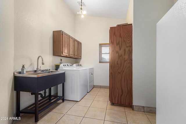 laundry area featuring a notable chandelier, washer and dryer, light tile patterned flooring, and cabinets