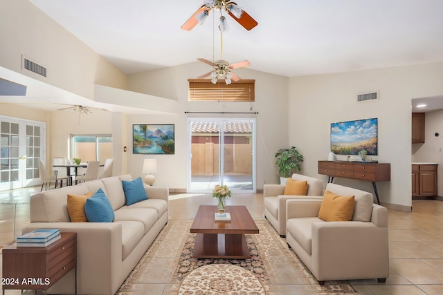 living room featuring french doors, light tile patterned floors, and high vaulted ceiling