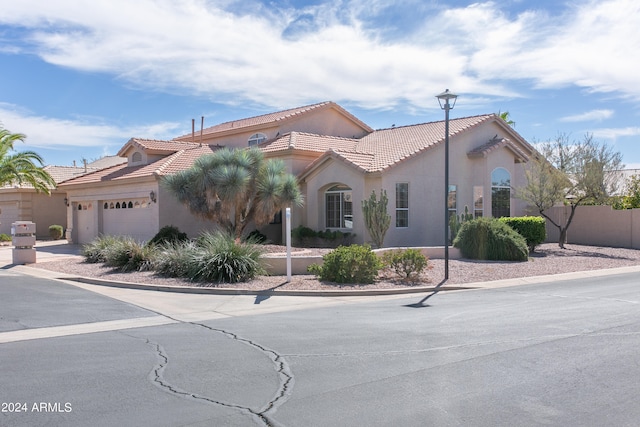 mediterranean / spanish-style house with a garage