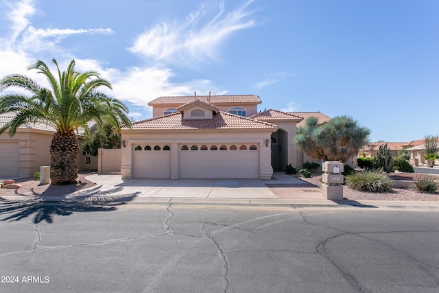 mediterranean / spanish-style house with a garage