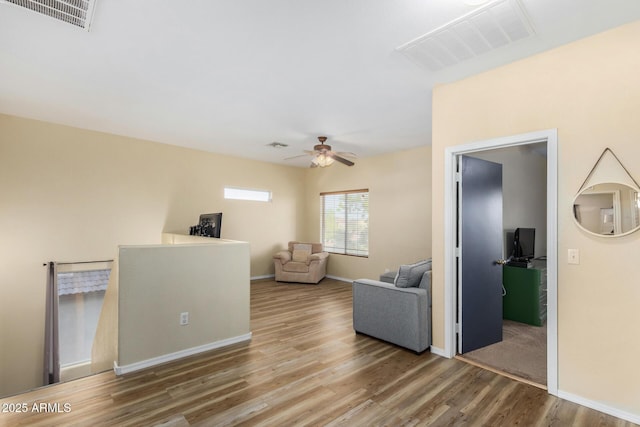 living room featuring ceiling fan and hardwood / wood-style floors