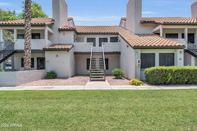 mediterranean / spanish-style house with a front lawn