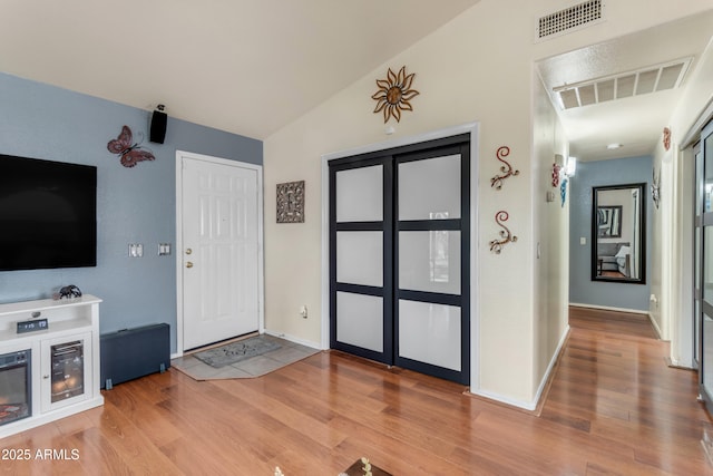 entryway featuring lofted ceiling and wood-type flooring