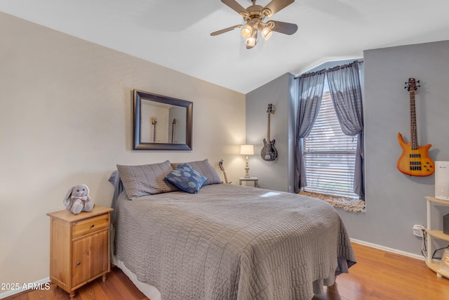 bedroom featuring ceiling fan, vaulted ceiling, and hardwood / wood-style floors