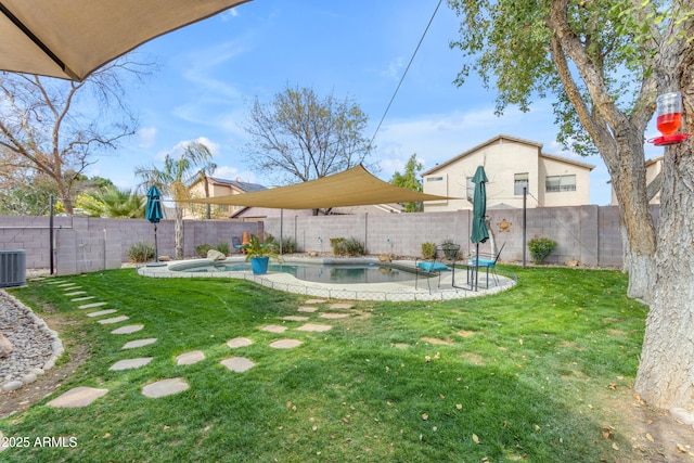 view of yard featuring a fenced in pool and central air condition unit