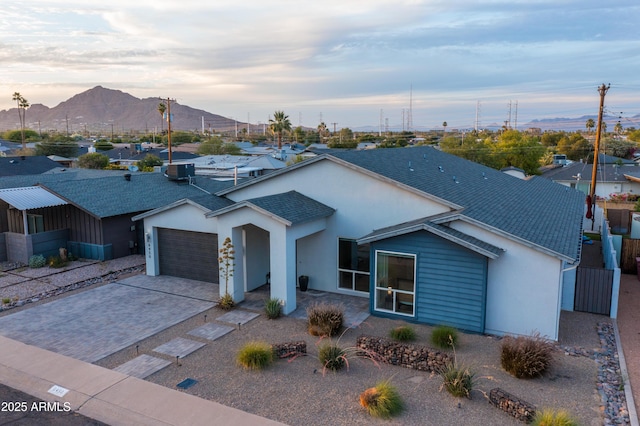 6450 E Vernon Ave, Scottsdale, AZ 85257 - ranch-style house with a garage, a mountain view, driveway, stucco siding, and a shingled roof