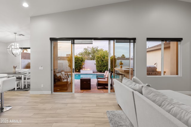6450 E Vernon Ave, Scottsdale, AZ 85257 - living area with a chandelier, healthy amount of natural light, light wood-style flooring, and recessed lighting