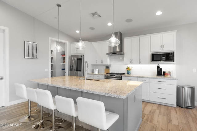 6450 E Vernon Ave, Scottsdale, AZ 85257 - kitchen featuring wall chimney exhaust hood, stainless steel appliances, a sink, backsplash, and white cabinets
