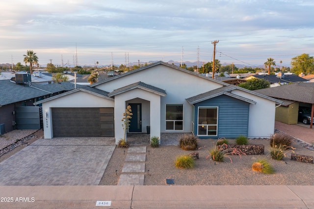 6450 E Vernon Ave, Scottsdale, AZ 85257 - view of front of home with a garage, driveway, stucco siding, and central air condition unit