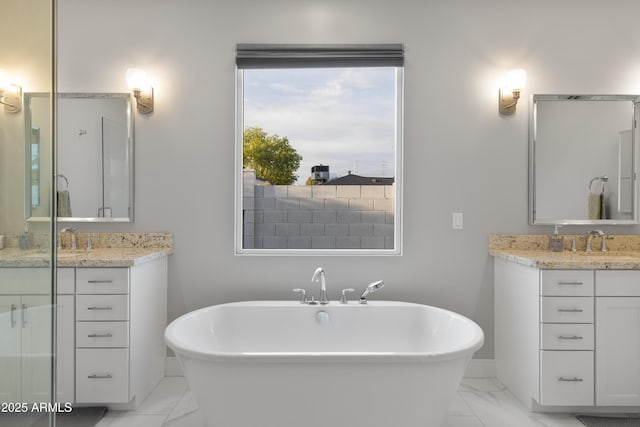 6450 E Vernon Ave, Scottsdale, AZ 85257 - bathroom featuring marble look tiles, a freestanding tub, and vanity