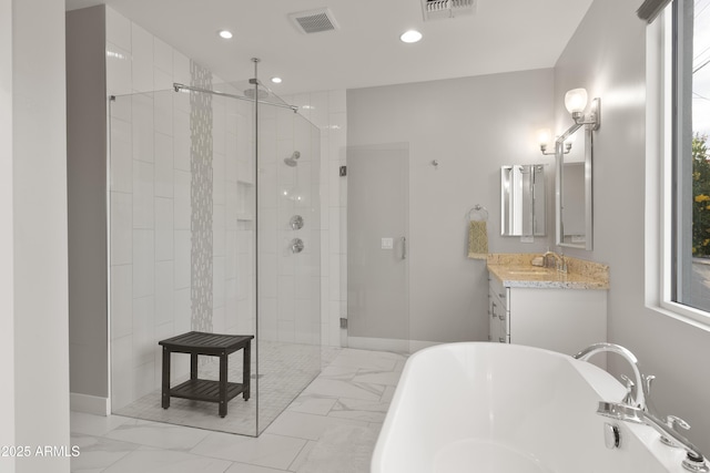 6450 E Vernon Ave, Scottsdale, AZ 85257 - bathroom with a freestanding bath, a shower stall, vanity, marble look tiles, and recessed lighting