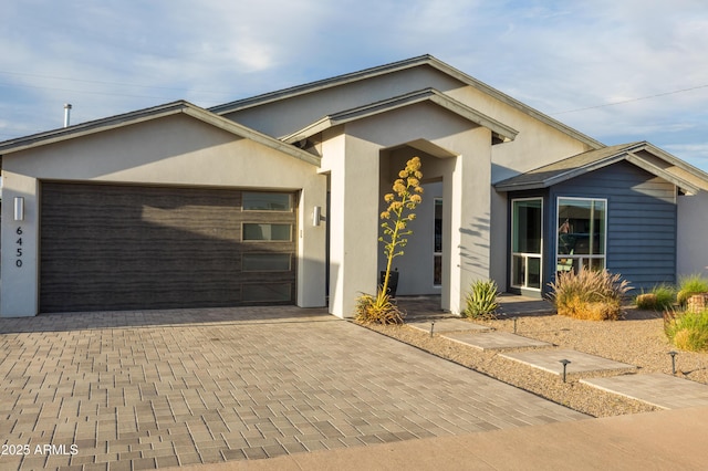 6450 E Vernon Ave, Scottsdale, AZ 85257 - ranch-style home with decorative driveway, a garage, and stucco siding