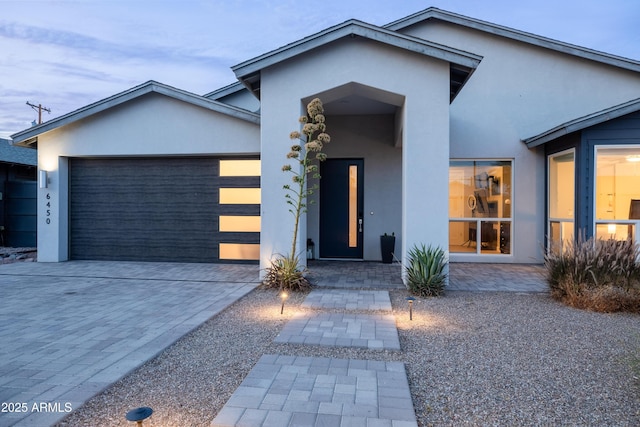 6450 E Vernon Ave, Scottsdale, AZ 85257 - view of front of home featuring stucco siding, an attached garage, and driveway