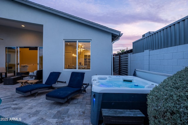 6450 E Vernon Ave, Scottsdale, AZ 85257 - patio terrace at dusk featuring a hot tub and a patio area