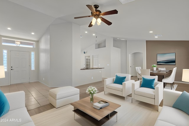 living room featuring ceiling fan, vaulted ceiling, and light hardwood / wood-style floors