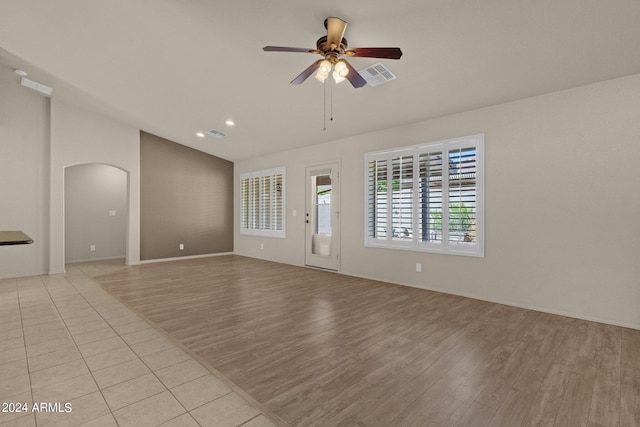 unfurnished living room with ceiling fan and light wood-type flooring