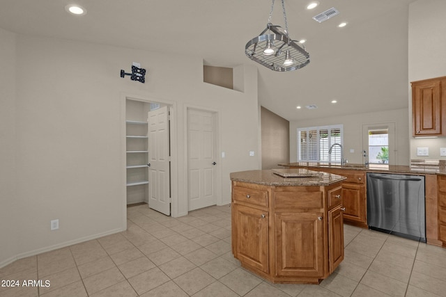 kitchen featuring a center island, stainless steel dishwasher, light tile patterned flooring, an inviting chandelier, and stone countertops