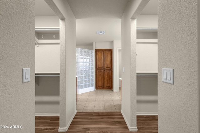 hall with hardwood / wood-style floors