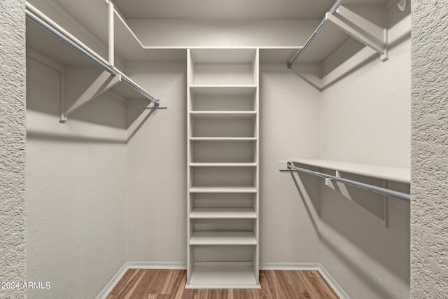 spacious closet featuring hardwood / wood-style floors