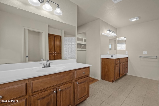 bathroom featuring vanity, tile patterned flooring, and a textured ceiling