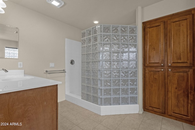 bathroom with tile patterned flooring, a shower, and vanity