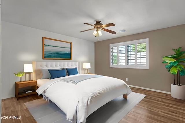 bedroom with ceiling fan and wood-type flooring