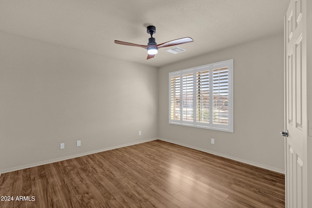 unfurnished room featuring hardwood / wood-style flooring and ceiling fan