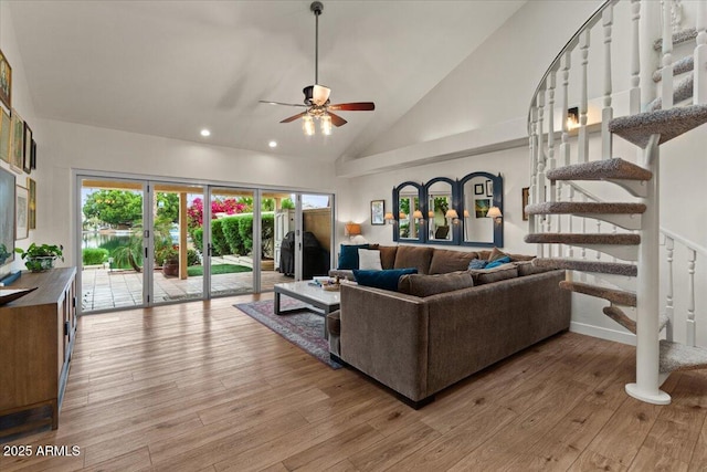 living area featuring wood finished floors, high vaulted ceiling, stairway, recessed lighting, and a ceiling fan