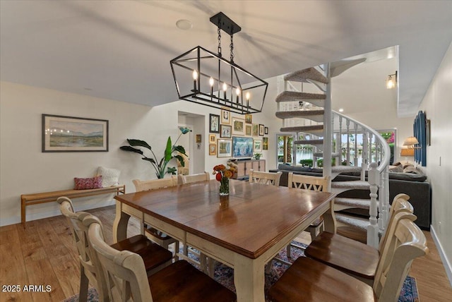 dining room featuring a notable chandelier and wood finished floors