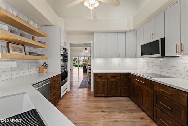 kitchen with a ceiling fan, dishwasher, light countertops, black electric stovetop, and light wood-style flooring