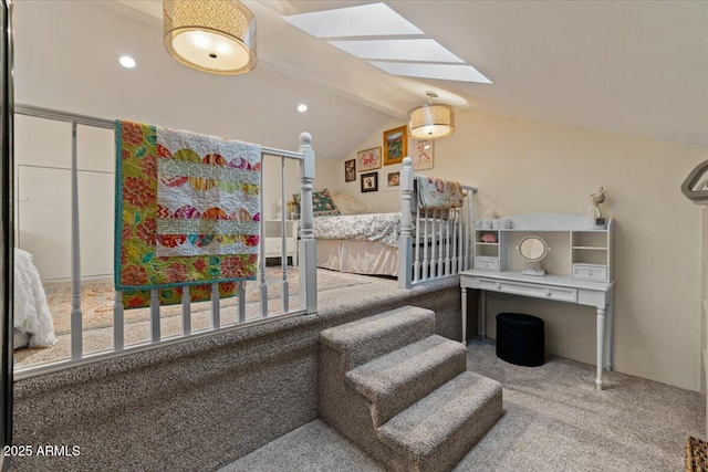 stairway with carpet floors and vaulted ceiling with skylight