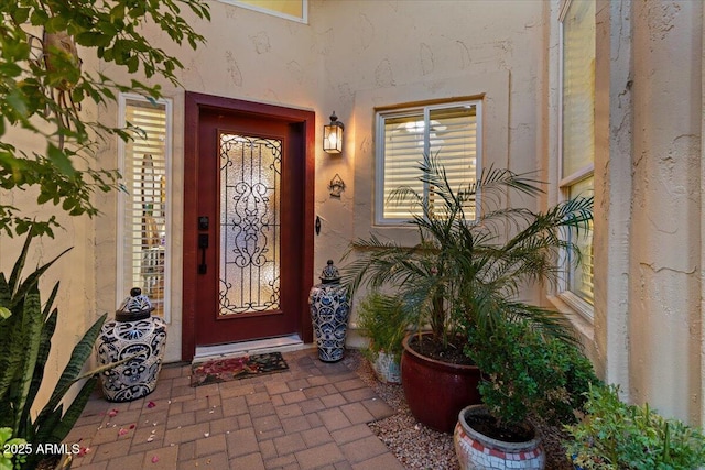 property entrance featuring stucco siding