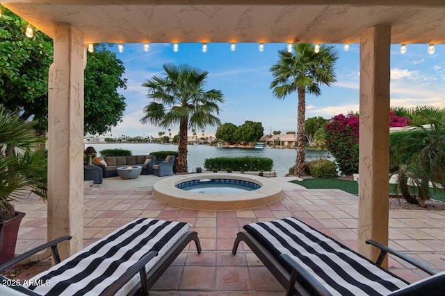 view of patio / terrace featuring a water view, an in ground hot tub, and an outdoor living space