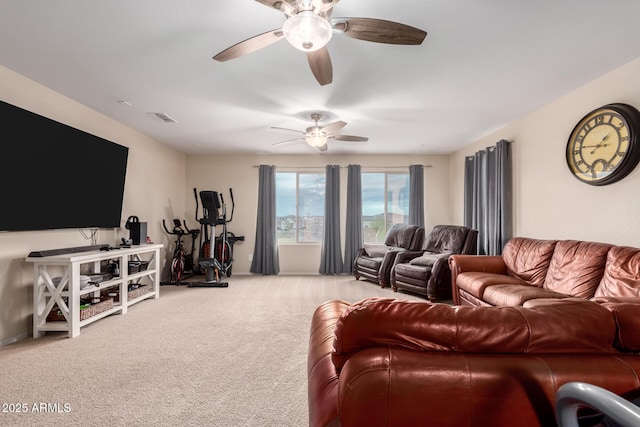 living room with visible vents, carpet flooring, and a ceiling fan