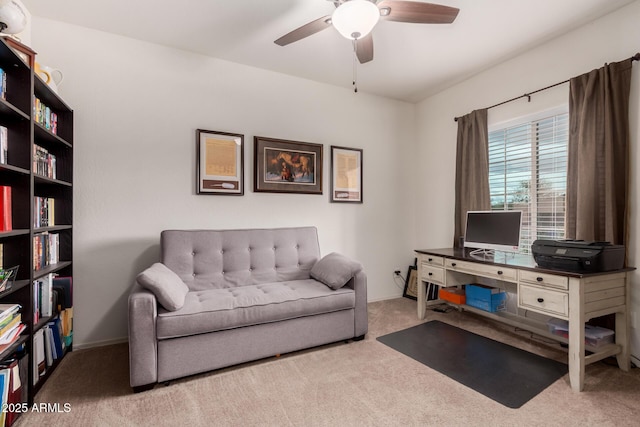 living area featuring carpet flooring, baseboards, and ceiling fan