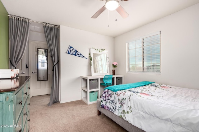 bedroom with a ceiling fan and light carpet