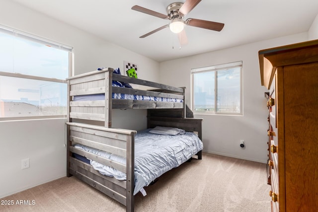 bedroom with baseboards, carpet floors, and ceiling fan