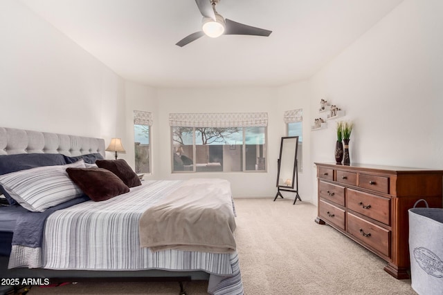 bedroom with light carpet and ceiling fan