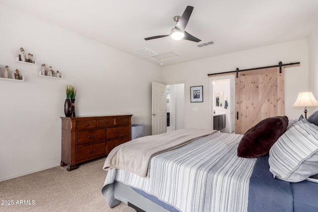 bedroom featuring a barn door, light colored carpet, visible vents, and ceiling fan