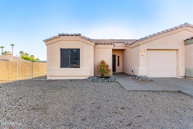 14216 N Saguaro Blvd Unit A, Fountain Hills, AZ 85268 - view of front of home featuring a tiled roof, a garage, fence, concrete driveway, and stucco siding