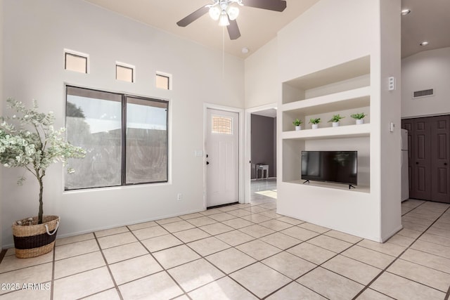 14216 N Saguaro Blvd Unit A, Fountain Hills, AZ 85268 - unfurnished living room with visible vents, a towering ceiling, built in shelves, a ceiling fan, and light tile patterned floors