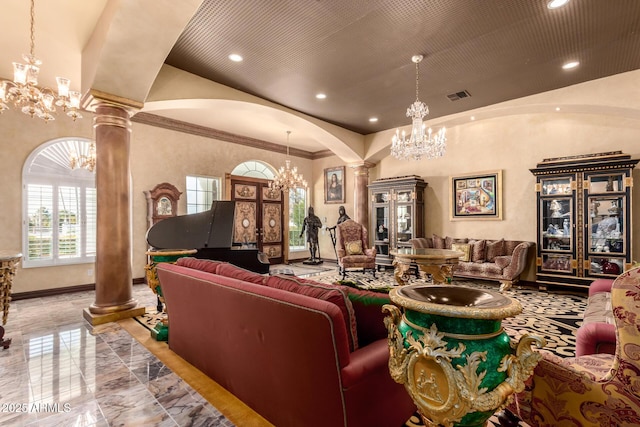 living room with an inviting chandelier, crown molding, and decorative columns