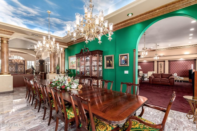 dining space with decorative columns, a raised ceiling, ceiling fan with notable chandelier, and crown molding