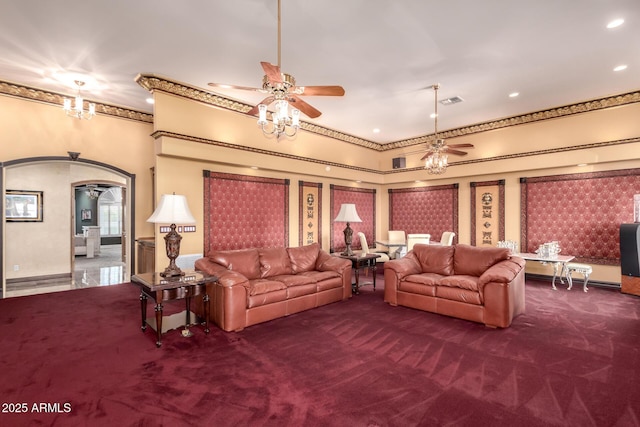 carpeted living room featuring ornamental molding and ceiling fan