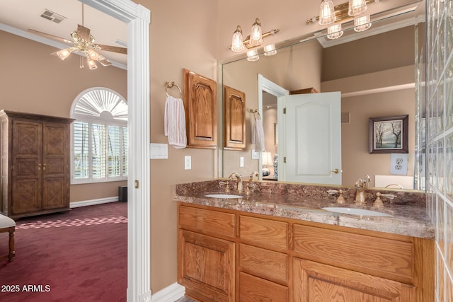 bathroom featuring ceiling fan, vanity, and ornamental molding