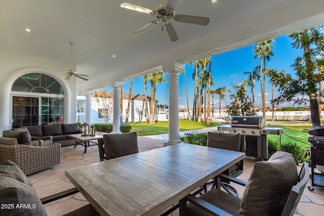 view of patio with ceiling fan, an outdoor living space, and area for grilling