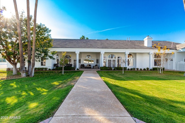 ranch-style home with a front lawn