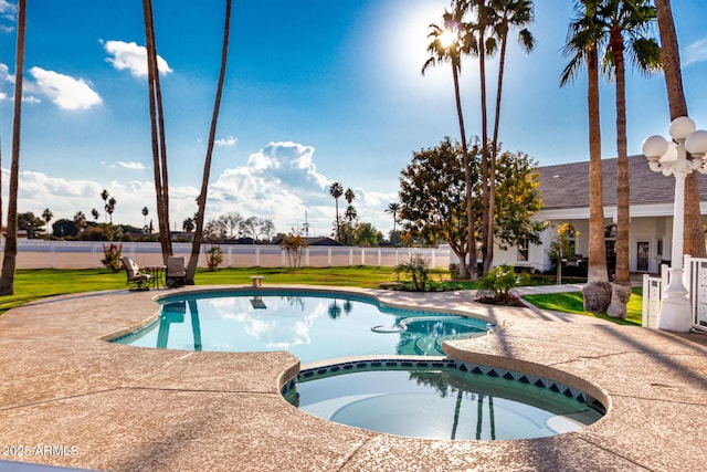 view of swimming pool with an in ground hot tub and a patio area