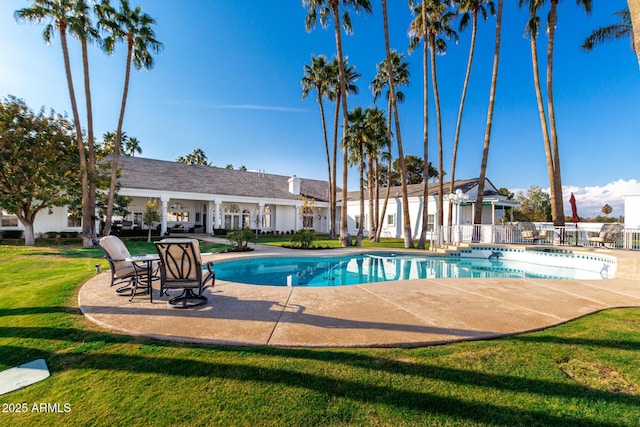 view of swimming pool featuring a patio area and a lawn