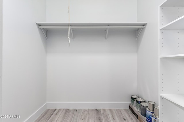 walk in closet featuring light hardwood / wood-style flooring